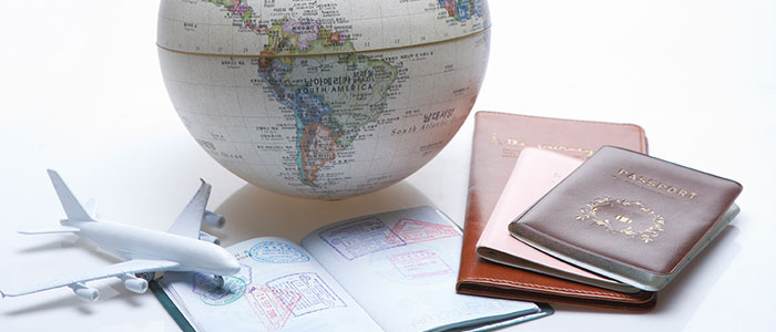 Airplane model, globe, passport, notebook reminding of overseas travel